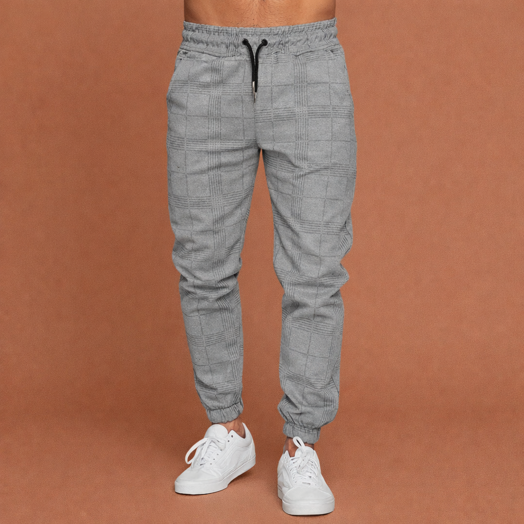 Heren joggingbroek in grijs met minimalistisch design, zacht en comfortabel voor casual en stijlvolle outfits.