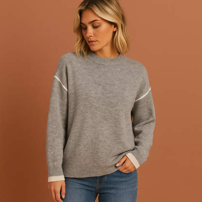 Grijze damestrui met oversized pasvorm en zachte afwerking, ideaal voor casual outfits en comfortabele herfstlooks.