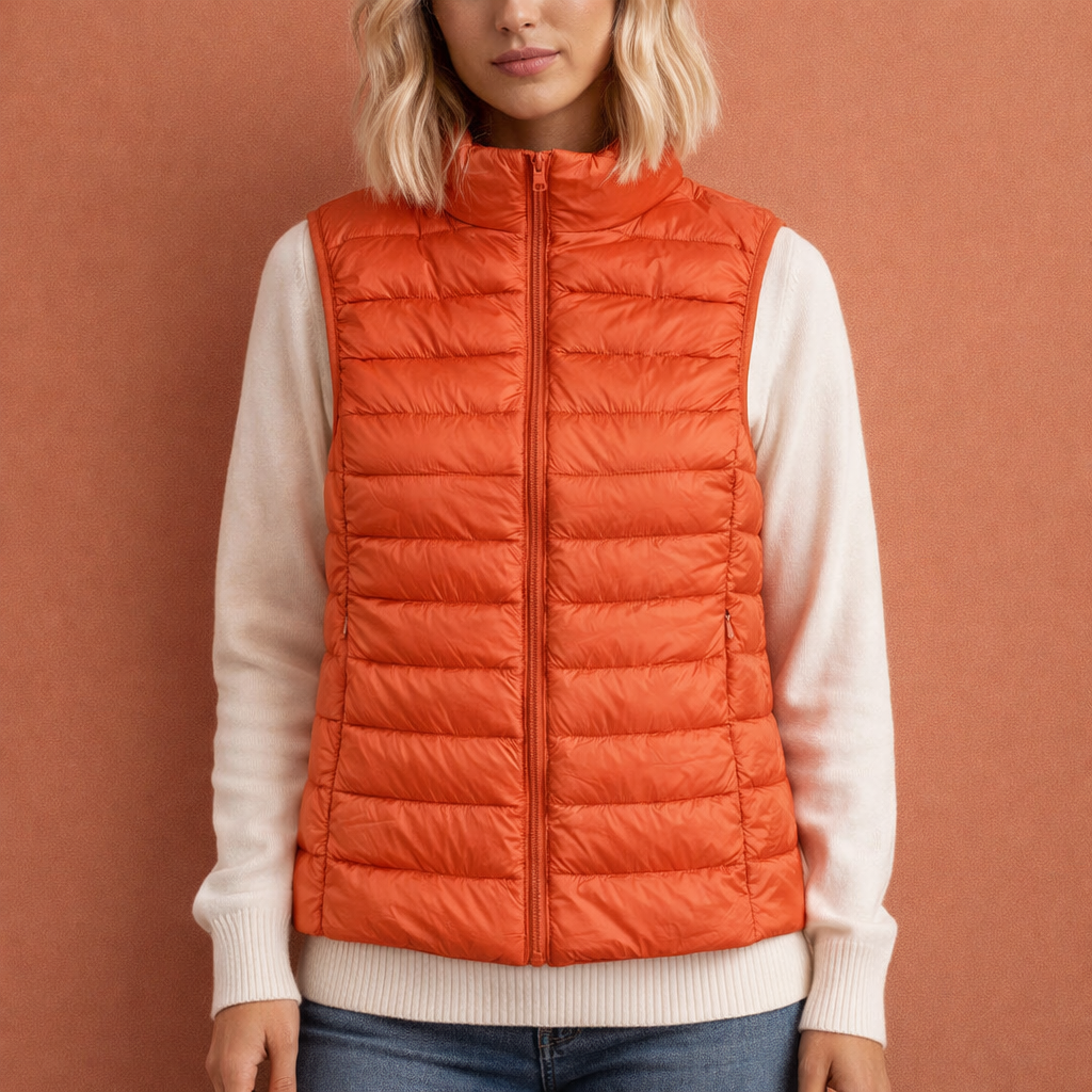Oranje dames mouwloze bodywarmer met ritssluiting en comfortabele pasvorm, ideaal voor dagelijks gebruik en koude dagen.