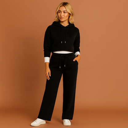 Zwart dames trainingspak met hoodie en wijde broek, geschikt voor casual outfits en dagelijks gebruik.
