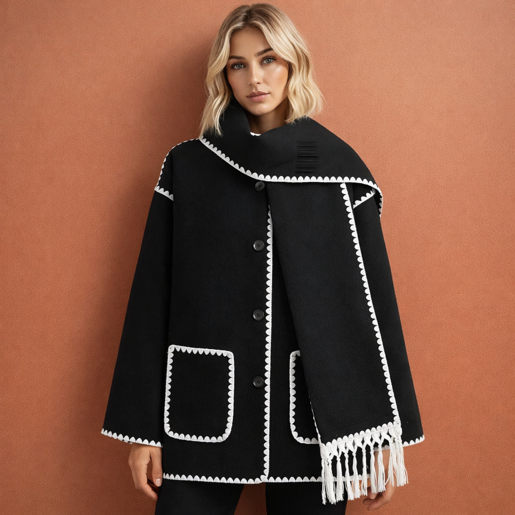 Zwarte elegante damesjas met ruime pasvorm en bijpassende sjaal, ideaal voor stijlvolle outfits tijdens koude dagen.